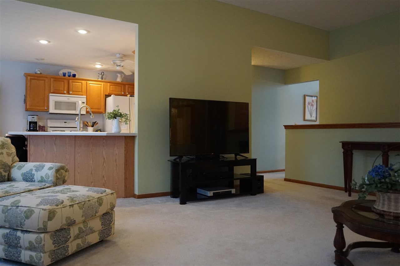 11123 Chicory Ridge Way Roscoe, IL 61073 - Photo 19 of 23 a living room with furniture and a flat screen tv