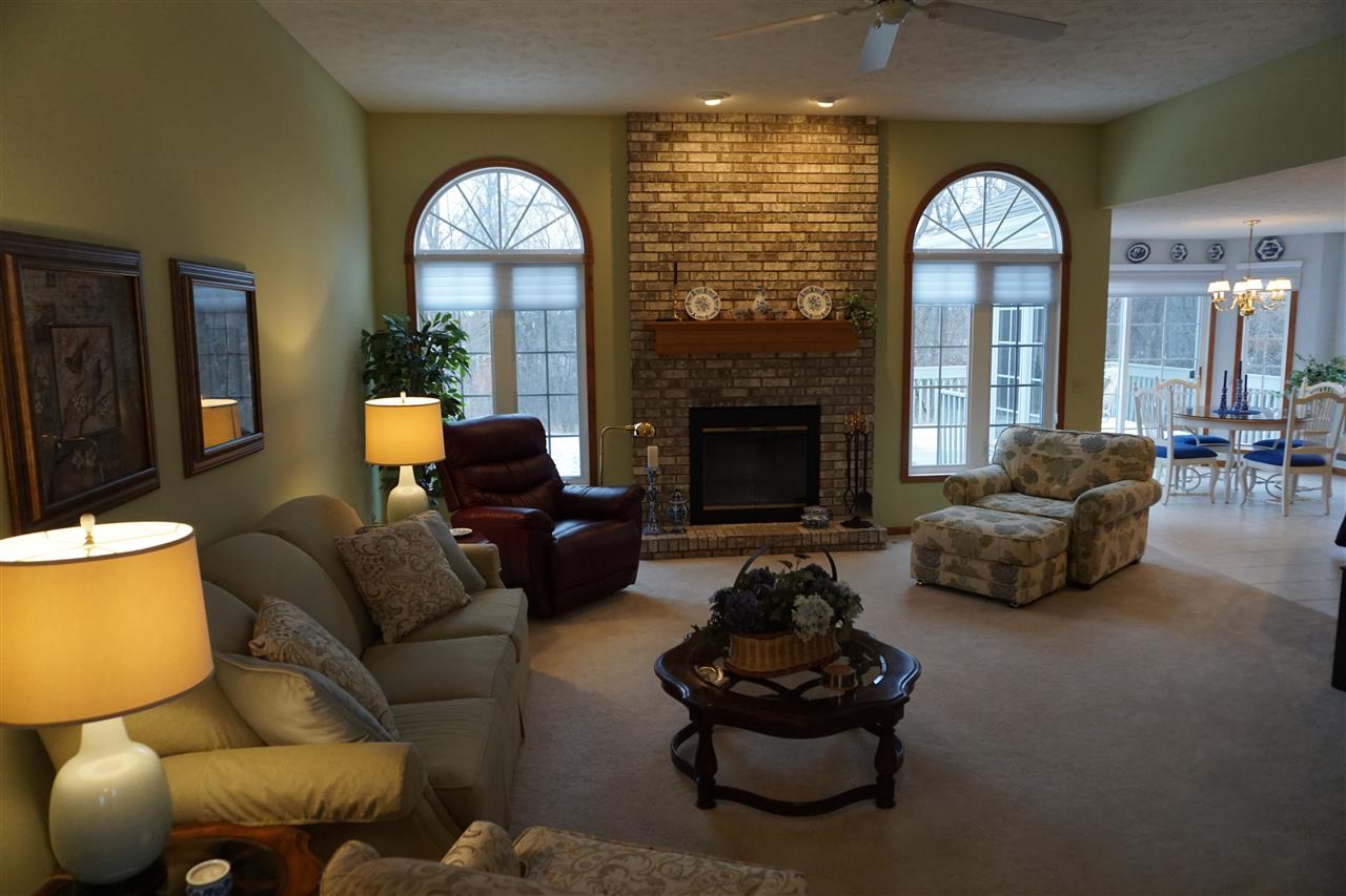 11123 Chicory Ridge Way Roscoe, IL 61073 - Photo 2 of 23 a living room with furniture a fireplace and a large window