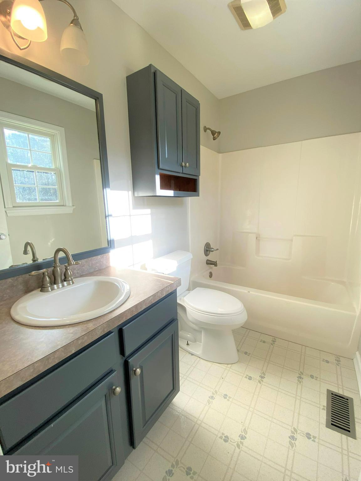 28849 Polks Road Princess Anne, MD 21853 - Photo 7 of 16 a bathroom with a toilet sink and mirror