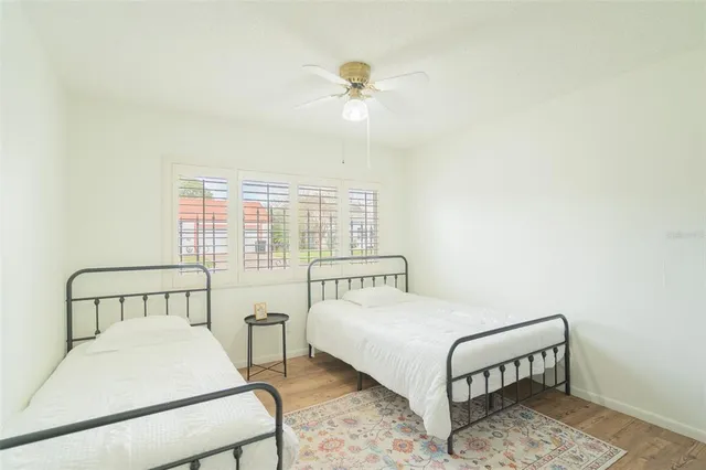 a bedroom with a bed a table and with a window