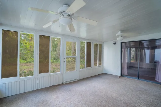 a view of an empty room with windows