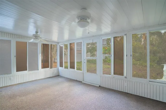 a view of an empty room with windows