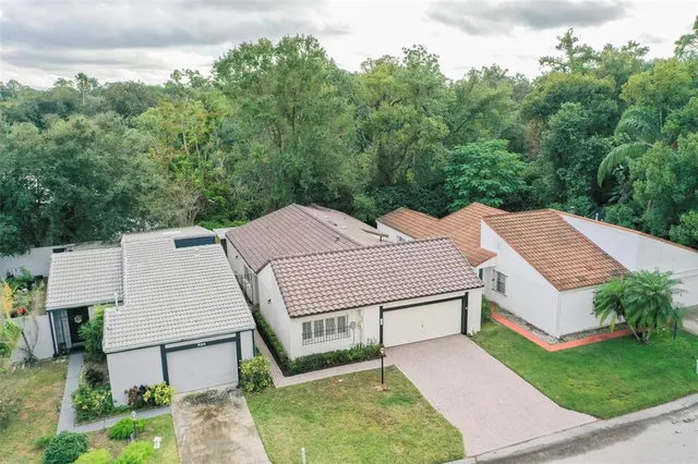 an aerial view of a house with a yard