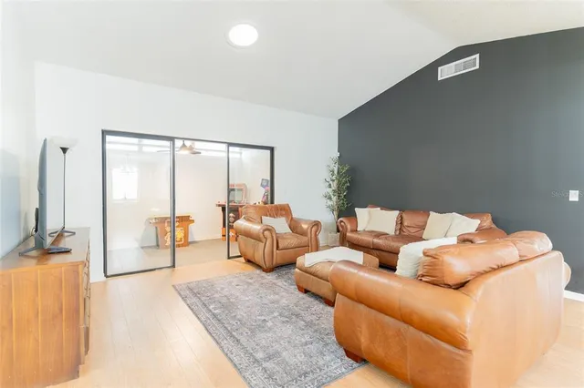 a living room with furniture and large windows