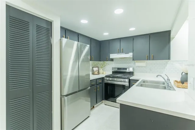 a kitchen with a refrigerator sink and stove
