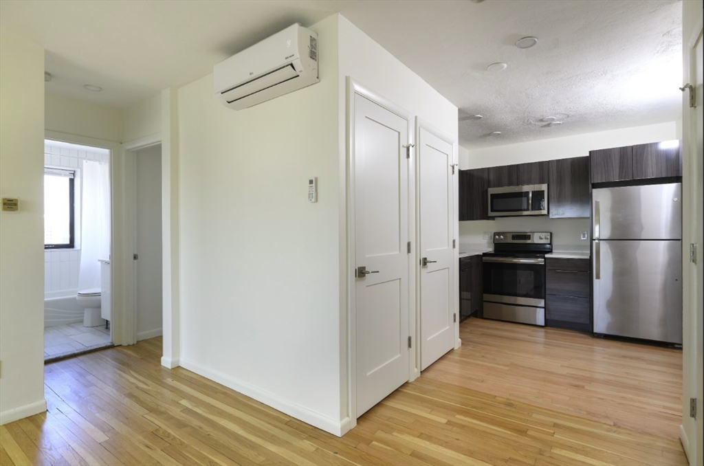 a kitchen with a refrigerator and a sink