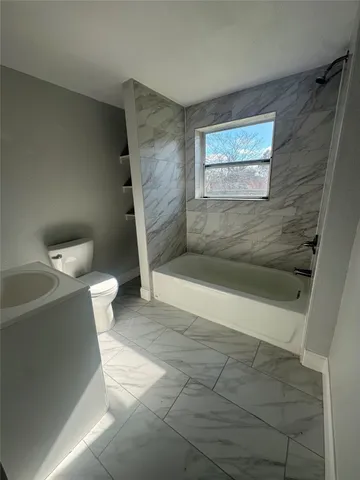 a view of a bathroom with a bathtub and toilet