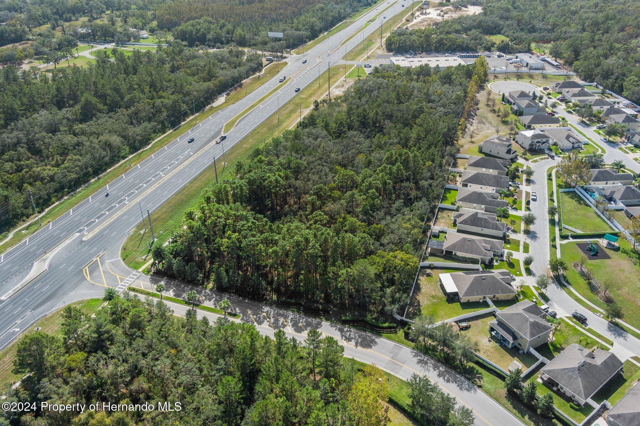 18119 Us-19 Hudson, FL 34667 - Photo 11 of 47 an aerial view of residential houses with outdoor space