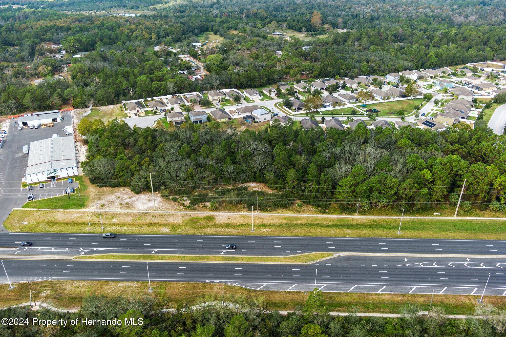 18119 Us-19 Hudson, FL 34667 - Photo 14 of 47 a view of a swimming pool with a garden and trees