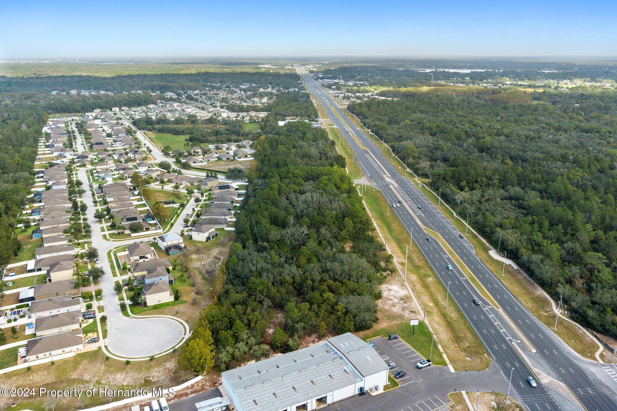 18119 Us-19 Hudson, FL 34667 - Photo 18 of 47 an aerial view of residential houses with outdoor space