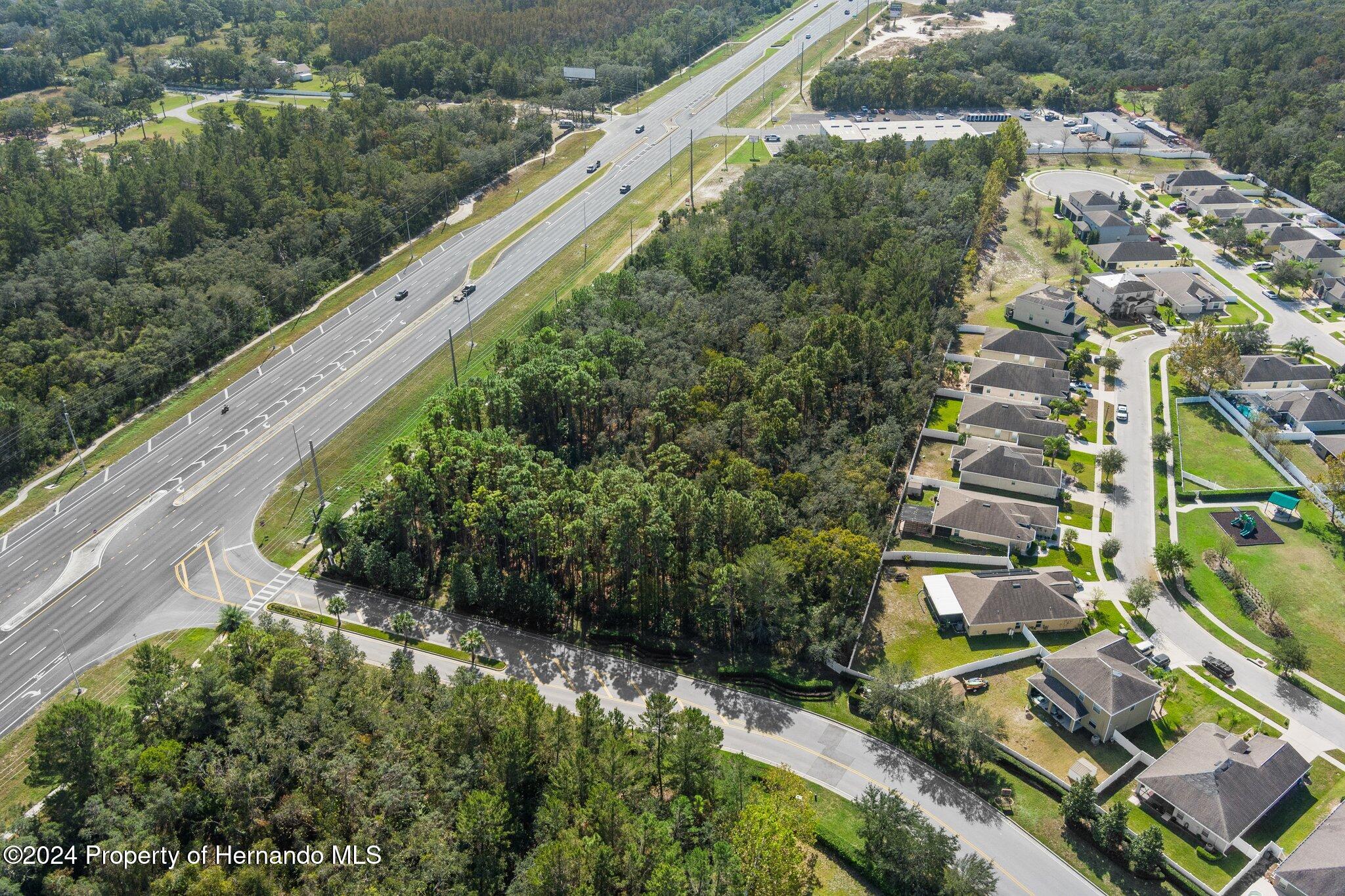 18119 Us-19 Hudson, FL 34667 - Photo 33 of 47 an aerial view of residential houses with outdoor space