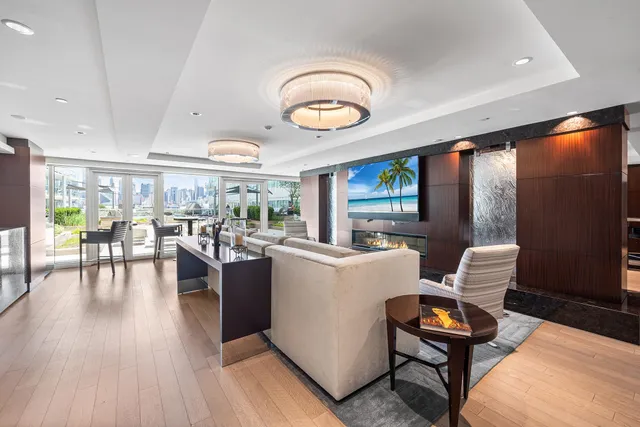 a living room with furniture a flat screen tv and a large window