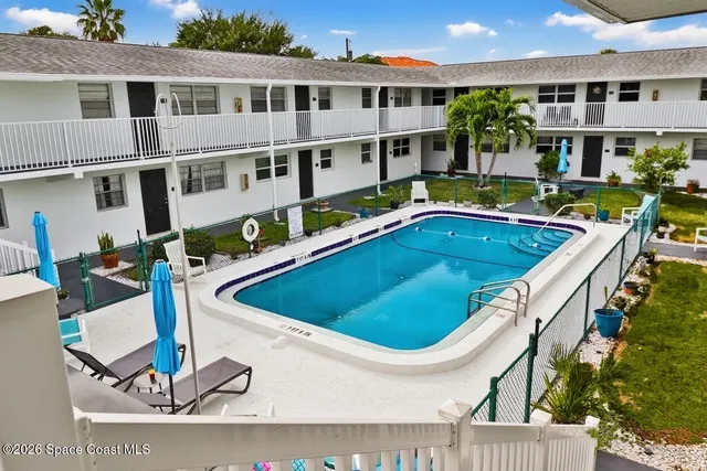 a view of a house with swimming pool and sitting area