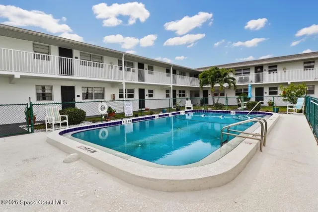 a view of a swimming pool with outdoor seating