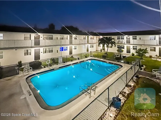 a room with pool table and chairs