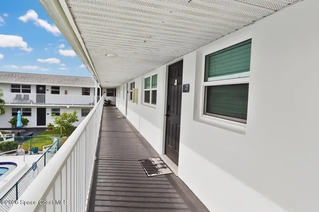 a view of a house with wooden deck