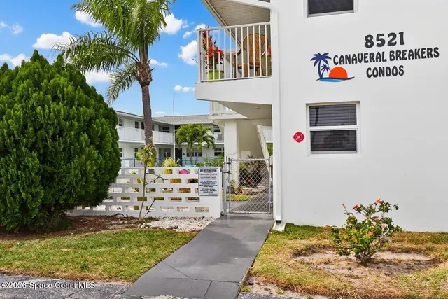 a front view of a house with outdoor seating