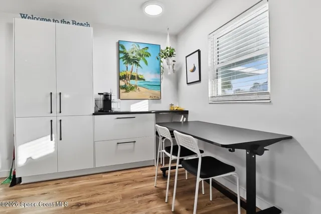 a view of a dining room with furniture and window