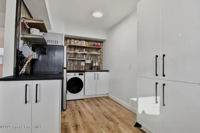 walk in closet with wooden floor