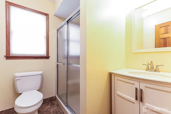 a bathroom with a toilet a sink and a mirror