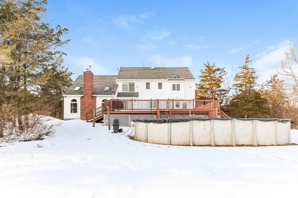 a view of a house with a yard and covered with snow