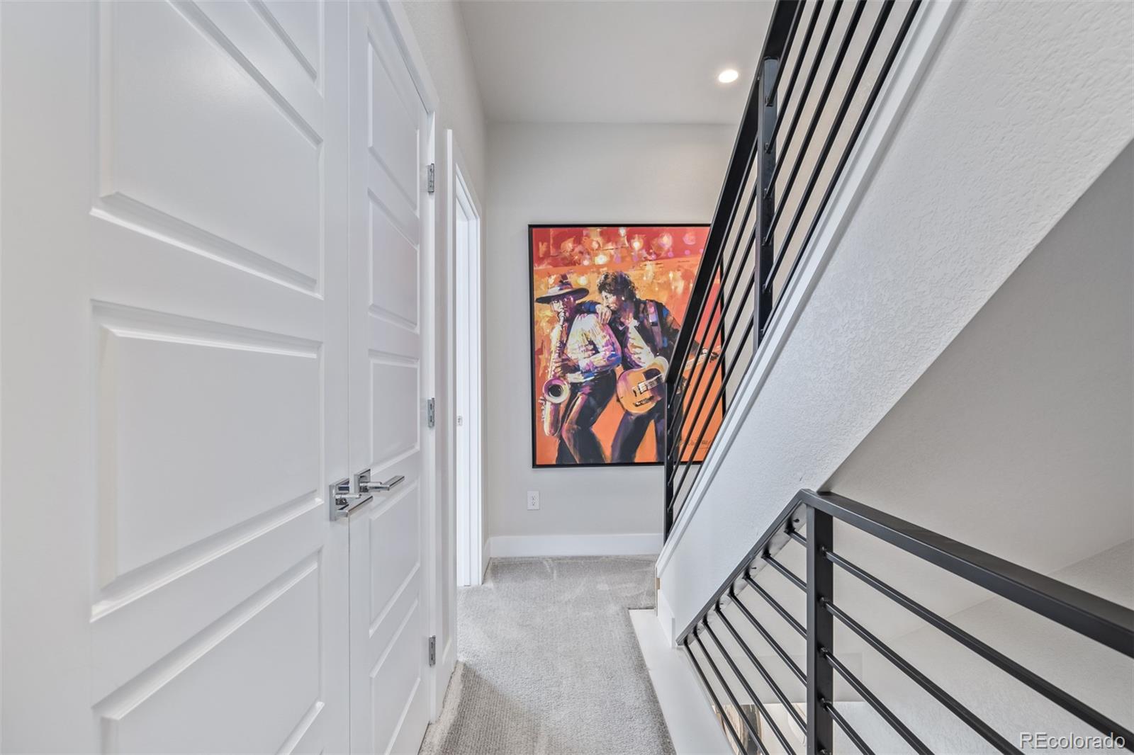 2350 Tremont Place, Unit 13 Denver, CO 80205 - Photo 17 of 41 a view of a hallway with wooden floor and staircase