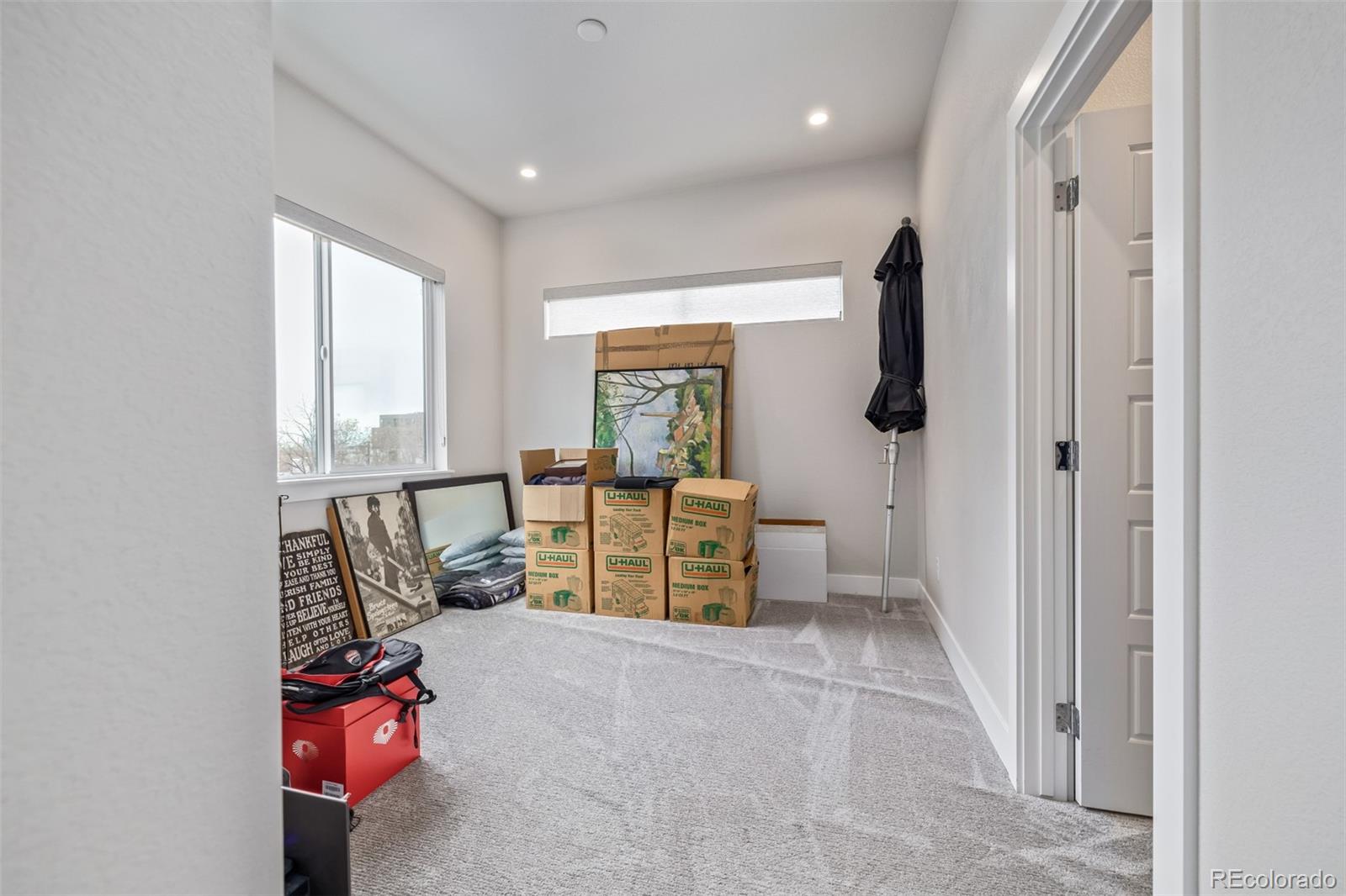 2350 Tremont Place, Unit 13 Denver, CO 80205 - Photo 18 of 41 a living room with furniture and a flat screen tv
