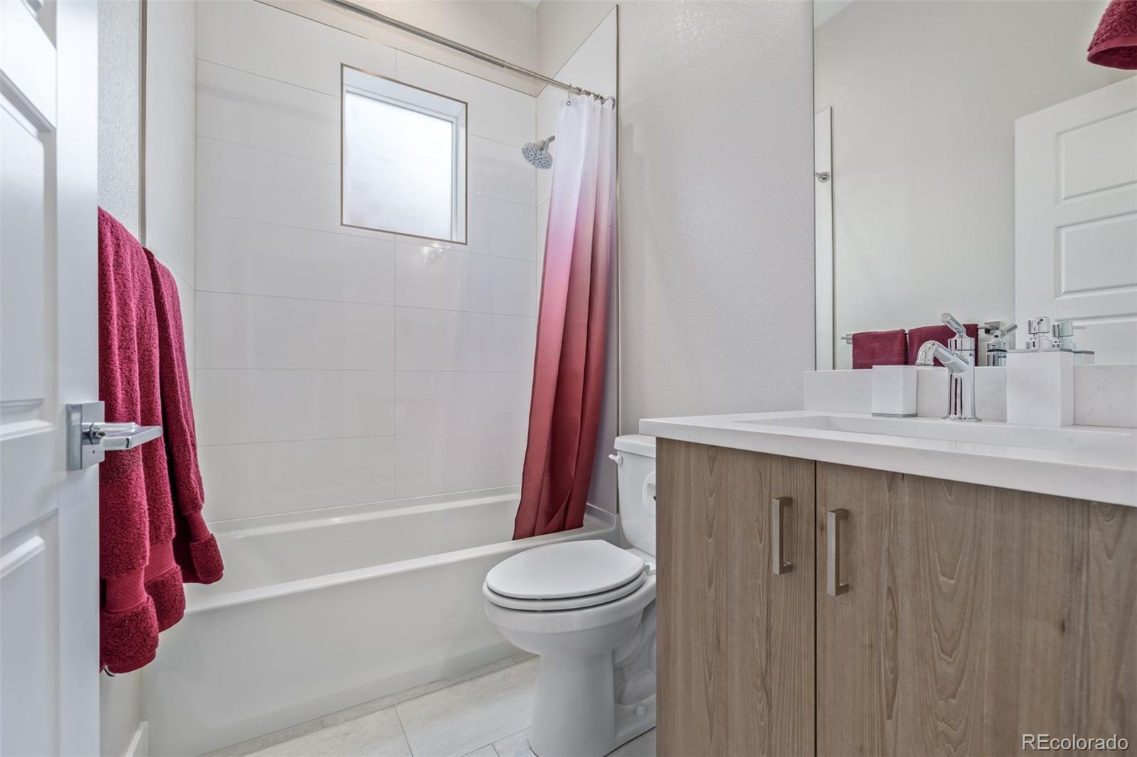 2350 Tremont Place, Unit 13 Denver, CO 80205 - Photo 20 of 41 a bathroom with a sink a toilet and shower