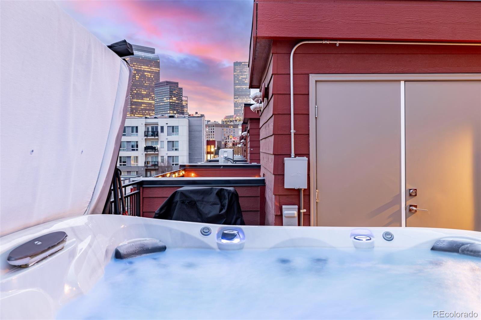 2350 Tremont Place, Unit 13 Denver, CO 80205 - Photo 32 of 41 a bedroom with a bed and a large window