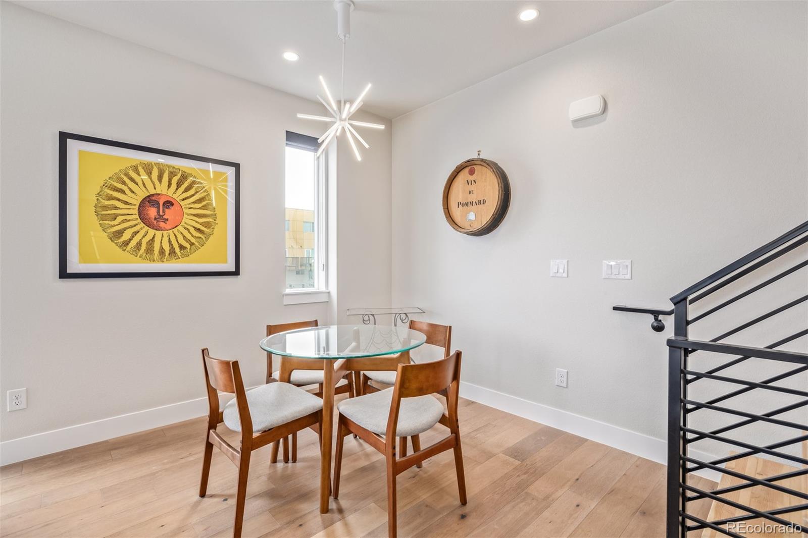 2350 Tremont Place, Unit 13 Denver, CO 80205 - Photo 9 of 41 a view of a dining area with furniture and a chandelier