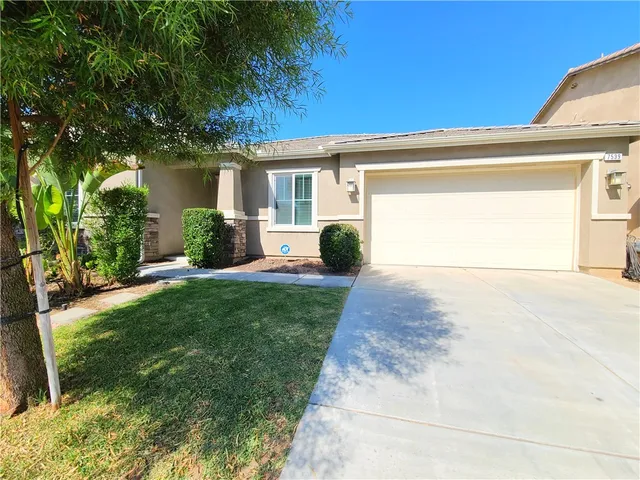 a view of a house with backyard and a garden