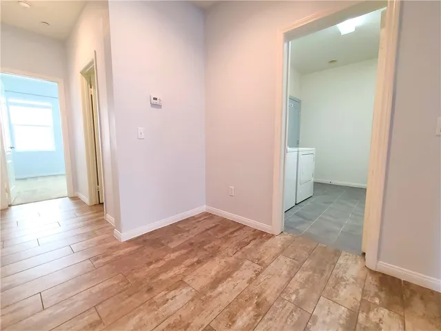 a view of a room with wooden floor and a bathroom