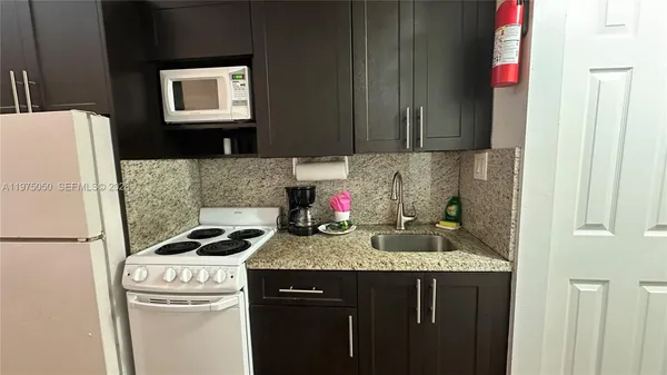 a kitchen with a sink a stove and refrigerator