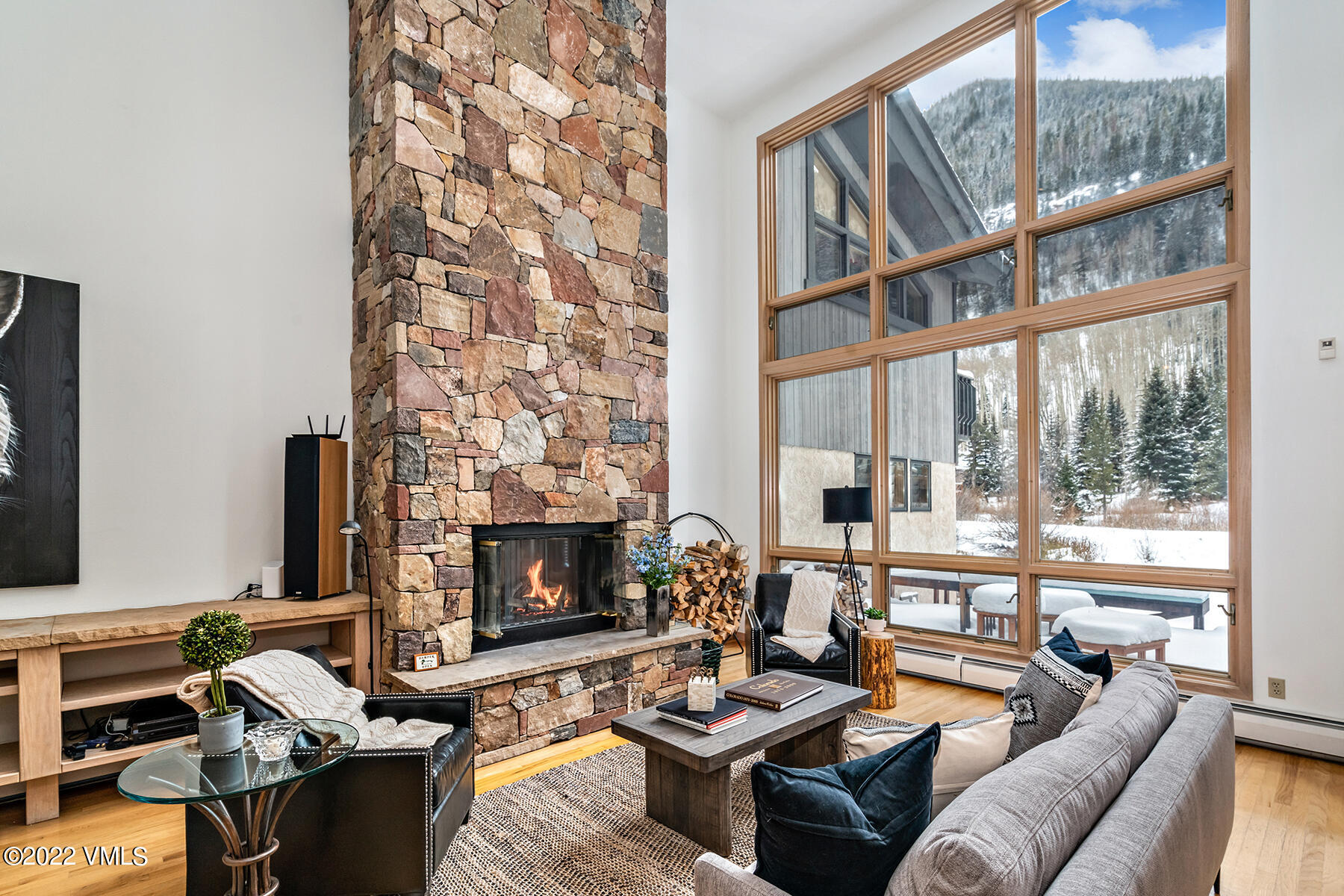 3984 Big Horn Road, Unit A Vail, CO 81657 - Photo 15 of 50 a living room with furniture fireplace and a floor to ceiling window