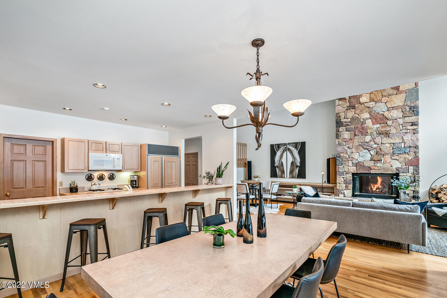 3984 Big Horn Road, Unit A Vail, CO 81657 - Photo 19 of 50 a kitchen with stainless steel appliances granite countertop a stove a kitchen island a dining table and chairs