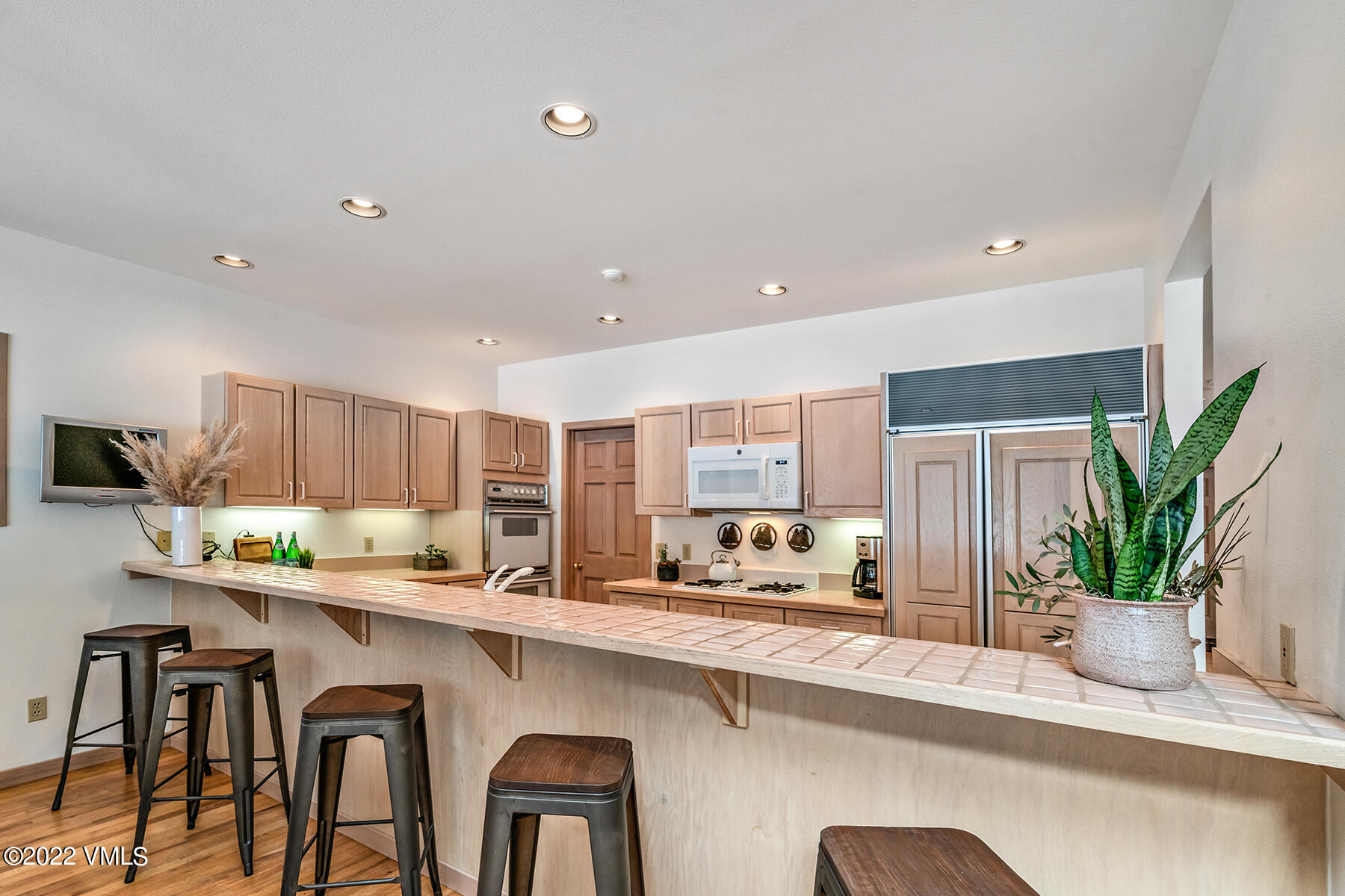 3984 Big Horn Road, Unit A Vail, CO 81657 - Photo 20 of 50 a kitchen with stainless steel appliances a sink a counter top space a large window and cabinets