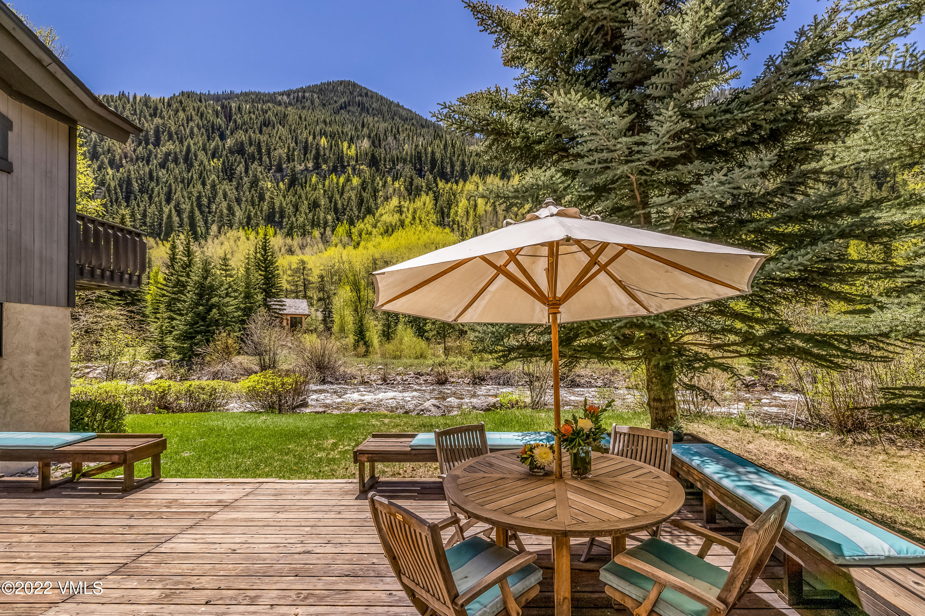 3984 Big Horn Road, Unit A Vail, CO 81657 - Photo 2 of 50 a backyard of a house with table and chairs