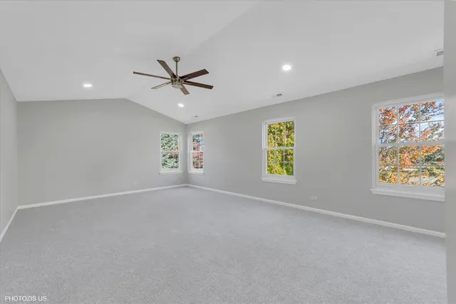 an empty room with closet and windows