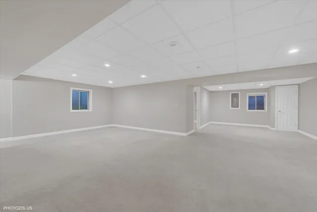 a bathroom with a toilet a sink a mirror and vanity