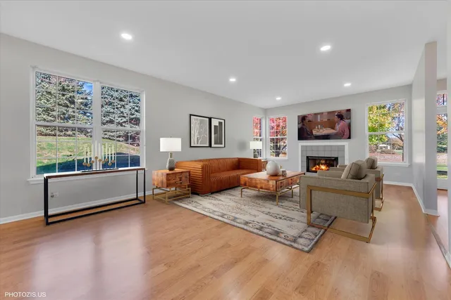 a living room with furniture large window and a fireplace