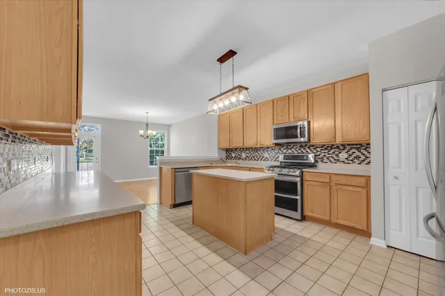 a kitchen with granite countertop white cabinets and stainless steel appliances