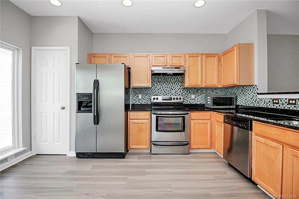 648 Raphael Place Charlotte, NC 28205 - Photo 2 of 48 a kitchen with stainless steel appliances granite countertop a refrigerator and a stove