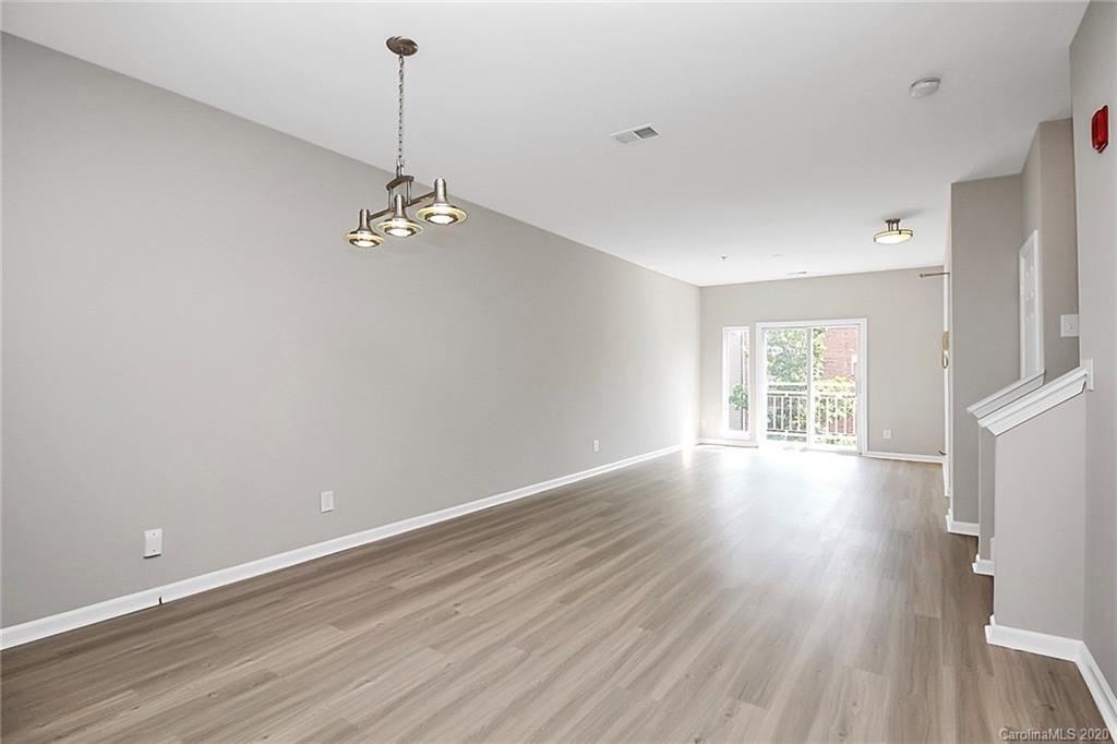 648 Raphael Place Charlotte, NC 28205 - Photo 11 of 48 a view of an empty room with wooden floor and a window