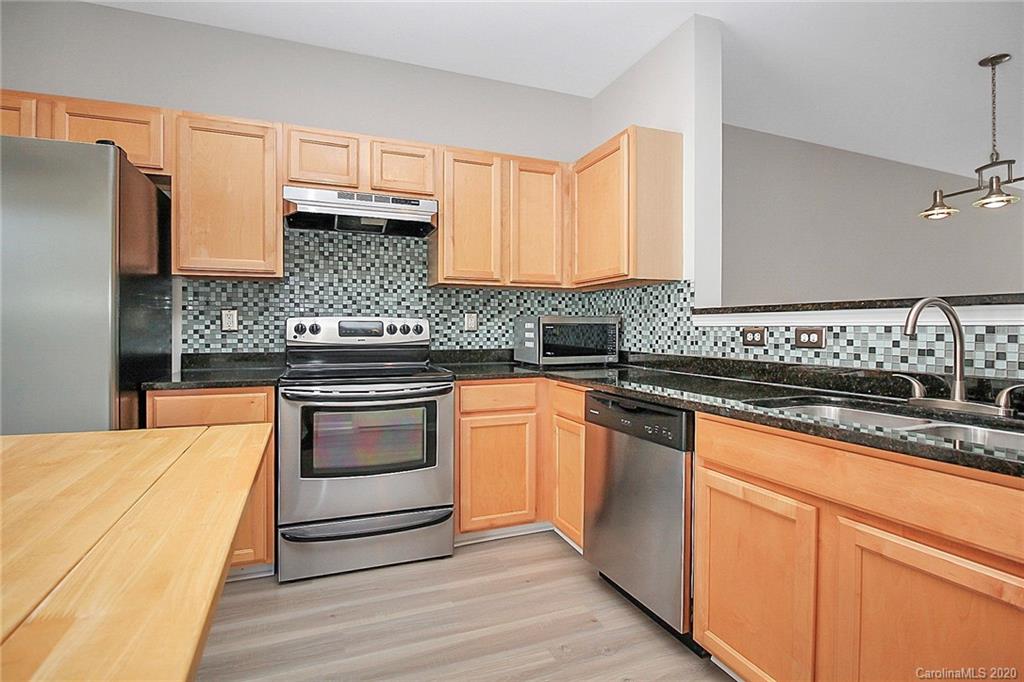 648 Raphael Place Charlotte, NC 28205 - Photo 14 of 48 a kitchen with granite countertop cabinets stainless steel appliances and a sink
