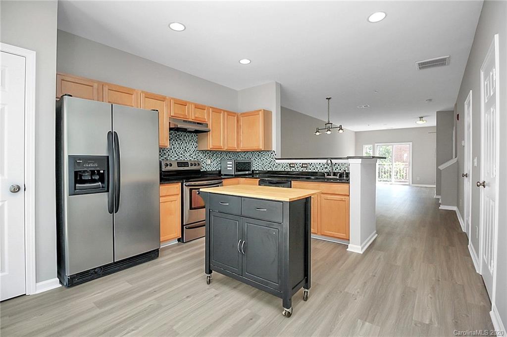 648 Raphael Place Charlotte, NC 28205 - Photo 15 of 48 a kitchen with wooden floors and refrigerator