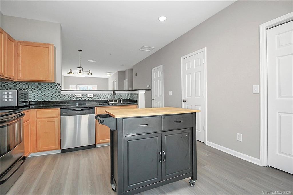 648 Raphael Place Charlotte, NC 28205 - Photo 17 of 48 a kitchen with granite countertop white cabinets and white appliances