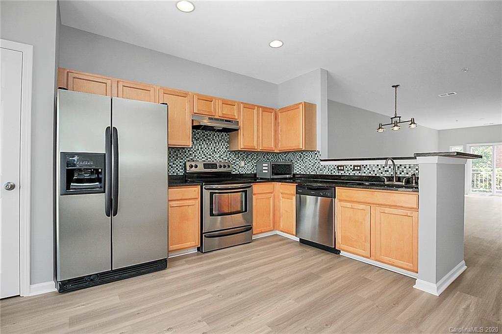 648 Raphael Place Charlotte, NC 28205 - Photo 20 of 48 a kitchen with stainless steel appliances granite countertop a refrigerator a sink and white cabinets