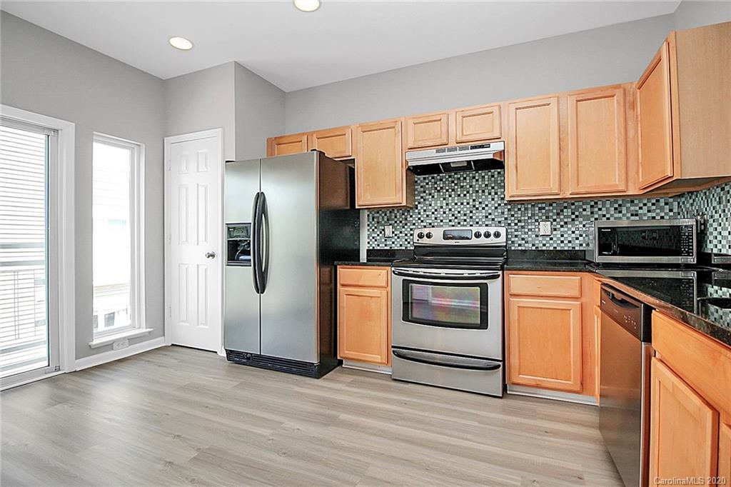 648 Raphael Place Charlotte, NC 28205 - Photo 21 of 48 a kitchen with granite countertop wooden cabinets and stainless steel appliances