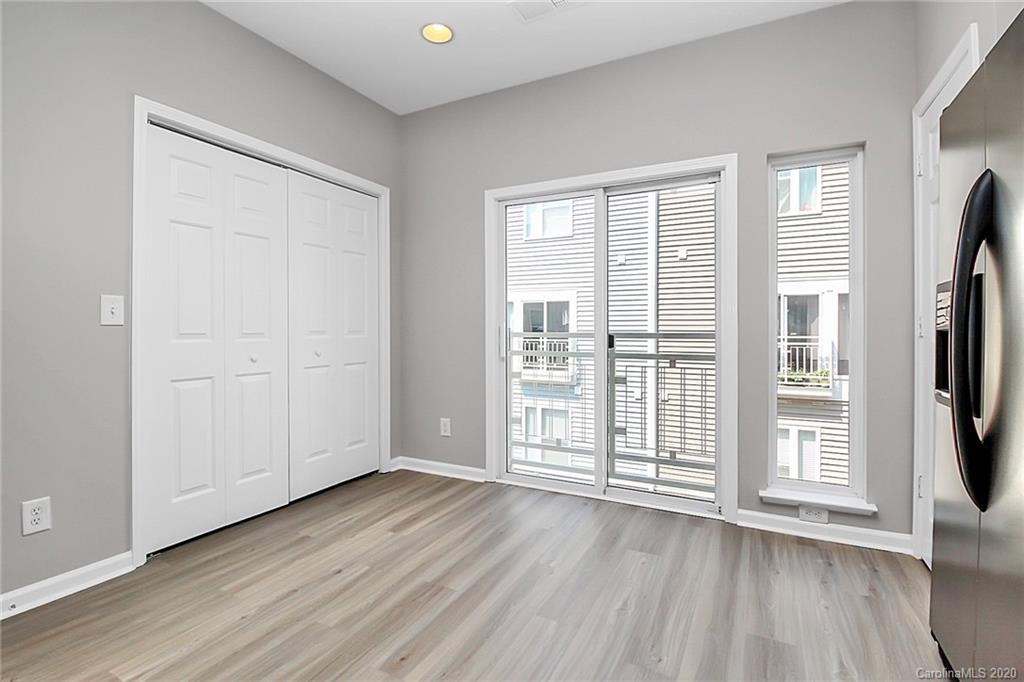 648 Raphael Place Charlotte, NC 28205 - Photo 22 of 48 an empty room with wooden floor and windows
