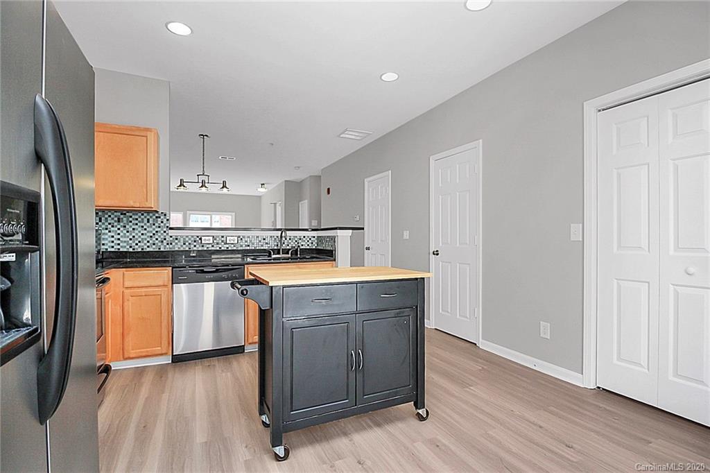 648 Raphael Place Charlotte, NC 28205 - Photo 24 of 48 a kitchen with stainless steel appliances granite countertop a stove a sink and a refrigerator